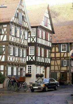 House in Schorndorf where Gottlieb Daimler was born. 
Daimler motor carriage of 1886 and a Mercedes-Benz 126 series S-Class coupe, 1980