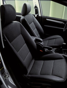 Mercedes-Benz A-Class, model series 169, 2004, interior of a Saloon. Compared to the preceding model series, the shoulder-room increased by up to 97 millimetres, vehicle occupants elbow room by up to 95 millimetres and kneeroom in the rear by 30 millimetres. 6-speed manual transmission (standard equipment in the A 180 CDI and A 200 CDI). As standard with multifunction steering wheel, electric window lifter in the front (2) with one-touchdown control, cup holder in the centre console. Equipment line AVANTGARDE (954) including black Maastricht fabric/ARTICO man-made leather (701) and trim elements in matt aluminium, leather steering wheel, gearshift lever and parking brake handle. Special equipment: Electric window lifter in the rear (2) (with automatic one-touch control and convenience closing in front and rear), PARKTRONIC (Code 220), Audio 50 APS radio with CD navigation system, electrically heated front seats, THERMOTRONIC automatic climate control (581).