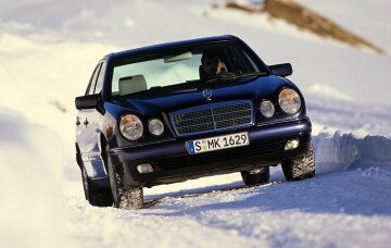 Mercedes-Benz E 320 4MATIC Limousine der Baureihe W 210: Fahraufnahme im Schnee von vorn aus dem Jahr 1997. 