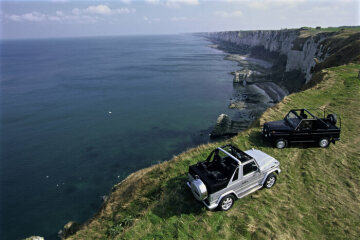 Mercedes-Benz 240 GD convertible, off-road vehicle, short wheelbase, 460 model series, 1979 - 1982 version (pictured on right). G 400 CDI Cabriolet, 463 model series, 2004. Brilliant silver metallic, black soft top, black leather. Spare wheel cover in stainless steel, stainless steel running boards on left and right (optional extras).