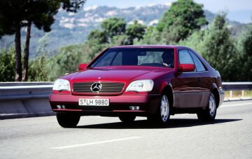 Mercedes-Benz 500 SEC (ab 06.1993: S 500 Coupé), Baureihe 140, Version 1992. Frontpartie geprägt von der SL-Kühlermaske, Coupé-Charakter ohne durchgehende B-Säulen, formintegrierte Heckleuchten. V8-Ottomotor M 119 mit 4.973 cm³ und 235 kW/320 PS. Almandinrot metallic (Metalliclackierung mit Mehrpreis), Polsterung Velours (Serienausstattung) Schwarz (Leder als Sonderausstattung). Schiebe-Hebe-Dach elektrisch (Serienausstattung), Scheinwerfer-Wischeranlage und 8-Loch Leichtmetall-Schmiederäder (Sonderausstattungen).