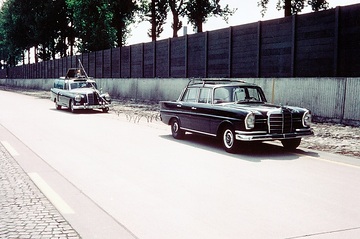 In the background: Mercedes-Benz 300 (W 189) as a measuring car. The one-off model was built in 1960. For vehicle development purposes, this unique vehicle was connected to the development vehicle via a cable, thus enabling it to record data from sensors providing dynamic measurements. Photo on the test track in Untertürkheim. In the foreground, a W 111 series saloon. 