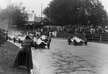 At the start to the Swiss Grand Prix on 21st August 1938, Dick Seaman is ahead of Rudolf Caracciola, both driving a Mercedes-Benz W 154. Caracciola takes the lead later, at the Bremgarten circuit near Bern, and wins the race, 20 seconds ahead of Seaman and von Brauchitsch.