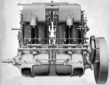 Mercedes 35 hp engine, produced from 1901 to 1903. High-performance four-cylinder engine of the Mercedes 35 HP, intake side. The lightweight crankcase, the two carburettors, the exposed intake camshaft and the control shaft for actuating the magneto make-and-break ignition are clearly visible.