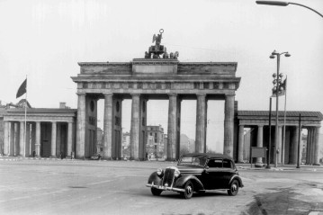 Der ehemalige  Dienstwagen Mercedes-Benz Typ 170 S Cabriolet B des Regierenden Bürgermeisters Ernst Reuter vor dem noch offenen Brandenburger Tor, 1960.