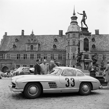 Anfahrt zum Großen Preis von Schweden bei Kristianstad, 7. August 1955. Parkplatz in Kopenhagen. Die drei Mercedes-Asse von links: Doppelsieger, Stirling Moss (2. Platz) und Juan Manuel Fangio (1. Platz) in der Rennsportwagen-Klasse mit Mercedes-Benz 300 SLR, Sieger Karl Kling (Startnummer 33) in der Tourenwagen-Klasse mit seinem Mercedes-Benz Tourensportwagen 300 SL.