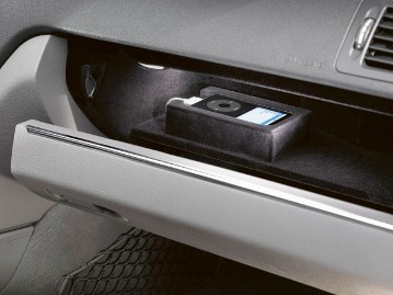 Mercedes-Benz C-Class Saloon and Estate, model series 204, 2007. With the Mercedes-Benz iPod® Interface Kit (accessory), the external iPod could be functionally integrated into the audio system. It could be placed in a black plastic cradle in the glove compartment (accessory).